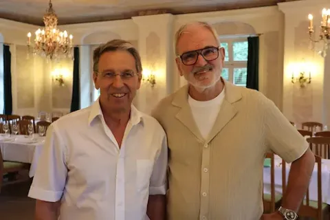 Peter-Mario Kubsch, der Geschäftsführer der Studiosus-Gruppe, und Manfred Häupl, der Geschäftsführer von Hauser Exkursionen, lächeln in die Kamera.