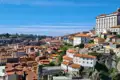 Panoramablick auf die Stadt Porto mit roten Ziegeldächern und historischen Gebäuden.