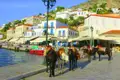 Traditionelle Eseltaxis am Hafen einer griechischen Inselstadt, mit weißen Häusern und Restaurants im Hintergrund.