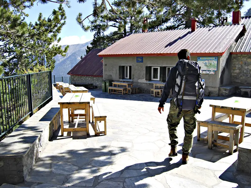 Wanderer erreicht Berghütte für eine Rast.