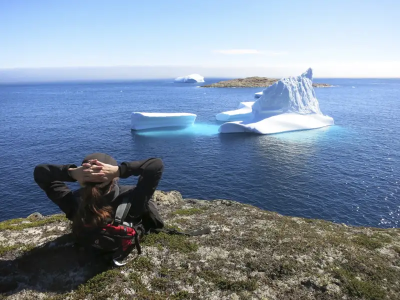 Reisender beobachtet Eisberge von der Küste aus.