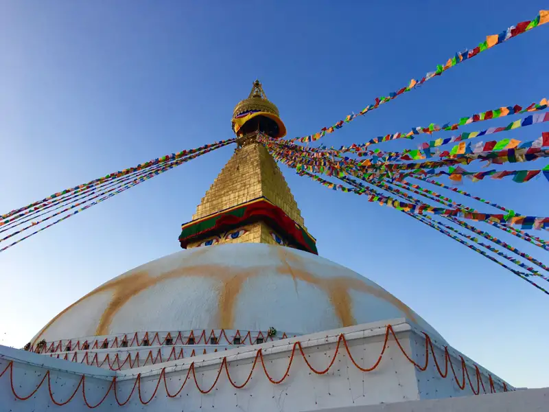 Boudhanath Stupa mit Gebetsfahnen im Wind.