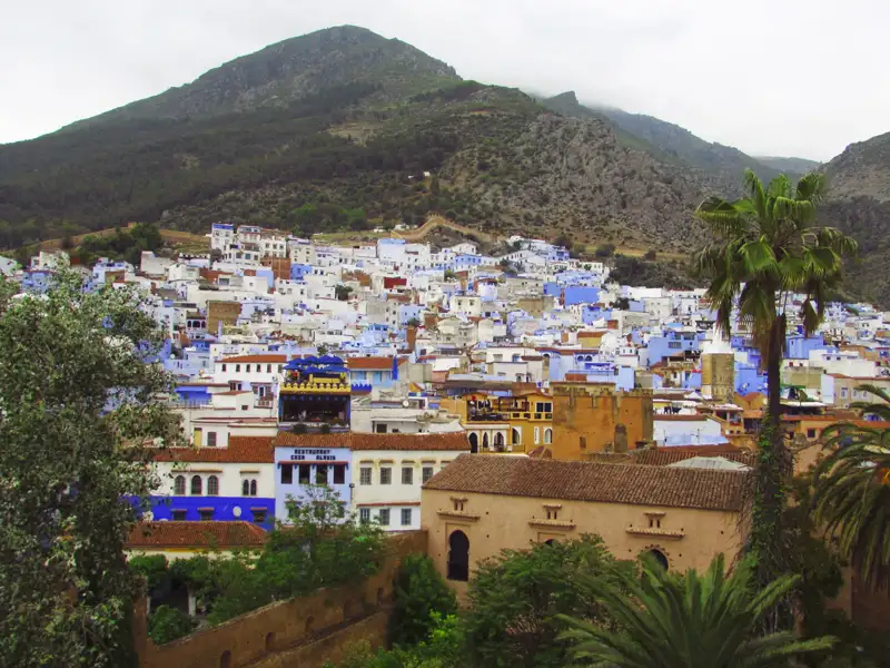 Blaue Häuser von Chefchaouen mit Bergen im Hintergrund.