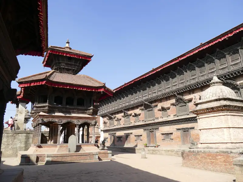Detailreiche Ansicht der traditionellen nepalesischen Architektur, die die kunstvollen Holzschnitzereien und die einzigartige Bauweise von Tempeln und Gebäuden in Kathmandu zeigt.