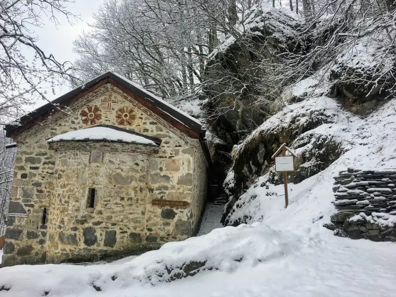 Steinkirche im Winter mit Schnee bedeckt.