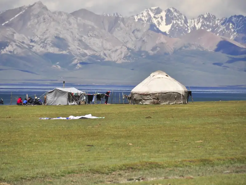 Unterkunft während der Reise: Jurte und Zelt am Seeufer mit Blick auf die Berge.