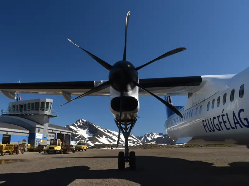 Flugzeug auf dem Flughafen vor einer Bergkulisse.