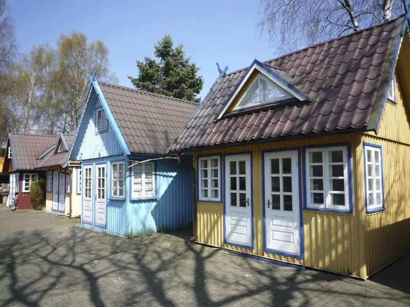 Bunte Holzhäuser in einer Reihe.