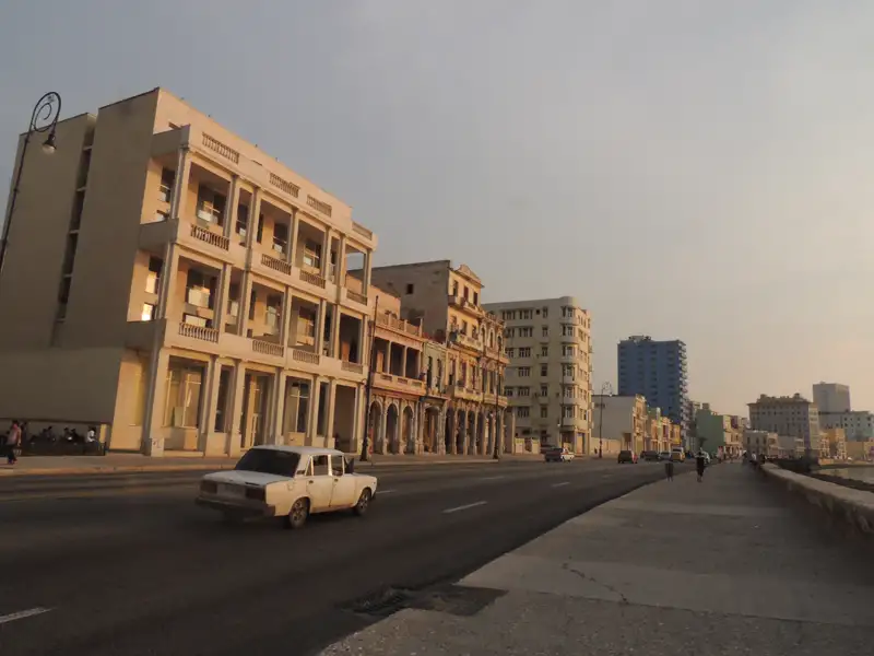 Historische Gebäude und ein altes Auto am Malecón in Havanna, Kuba.