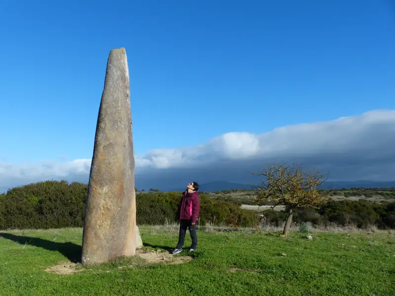 Reisender bei einem Menhir.