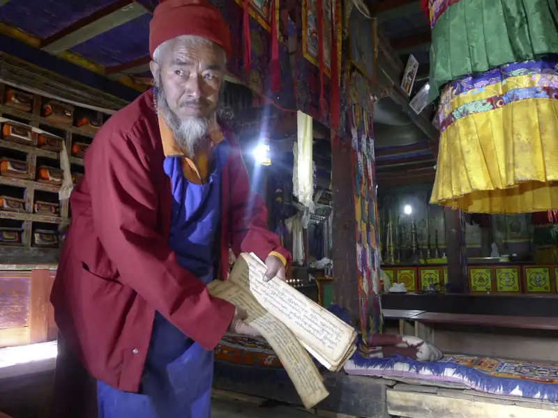Mönch mit alter Schriftrolle in einem Kloster.