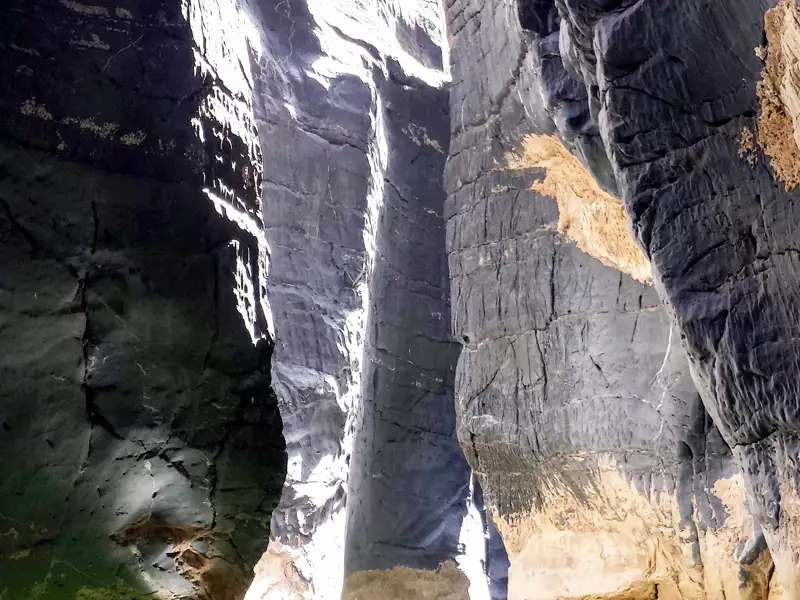 Steile Felswände einer engen Schlucht, die von unten fotografiert wurden.