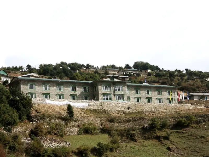 Gebäude mit grünen Fensterrahmen im Gebirge.